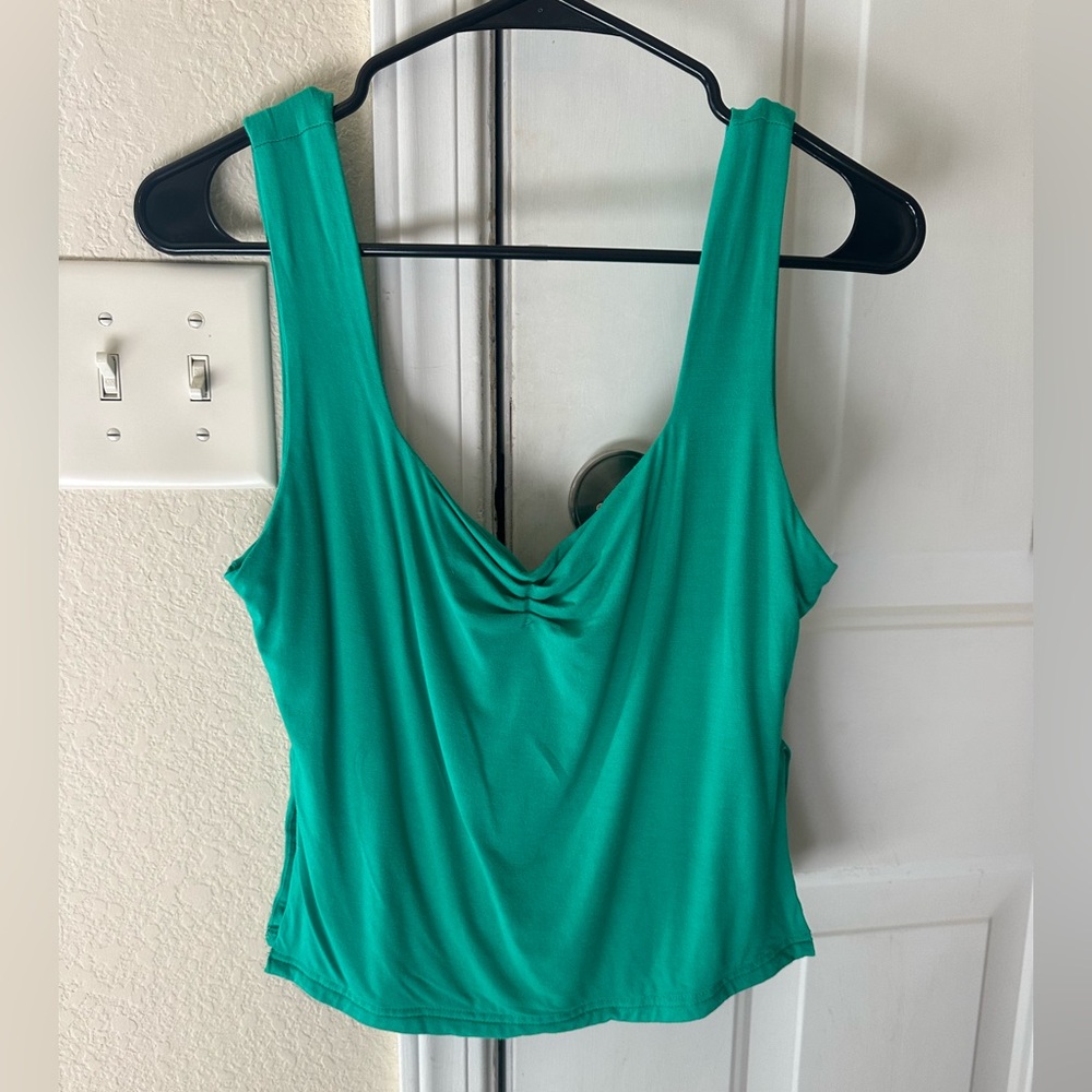 Green tank top with small slits on the sides